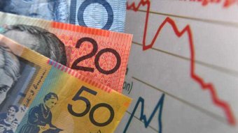 Australian currency is seen next to a wages graph