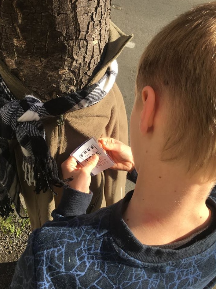 Oliver Edwards adjusts a label on a garment.