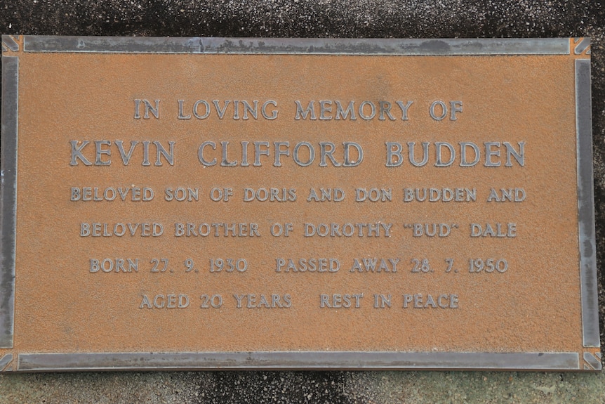 A brown grave stone that is in memory of Kevin Clifford Budden