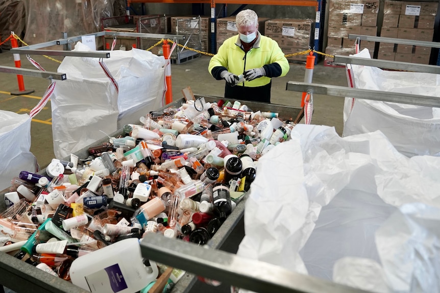 A recycling bin full of cosmetic products