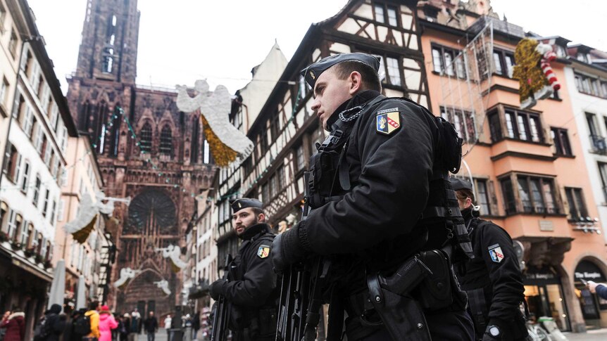 French gendarme walk down the streets with guns in the city of Strasbourg