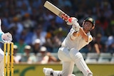 Australia's David Warner smashes a six off Graeme Swann on day three of the Third Test at the WACA.