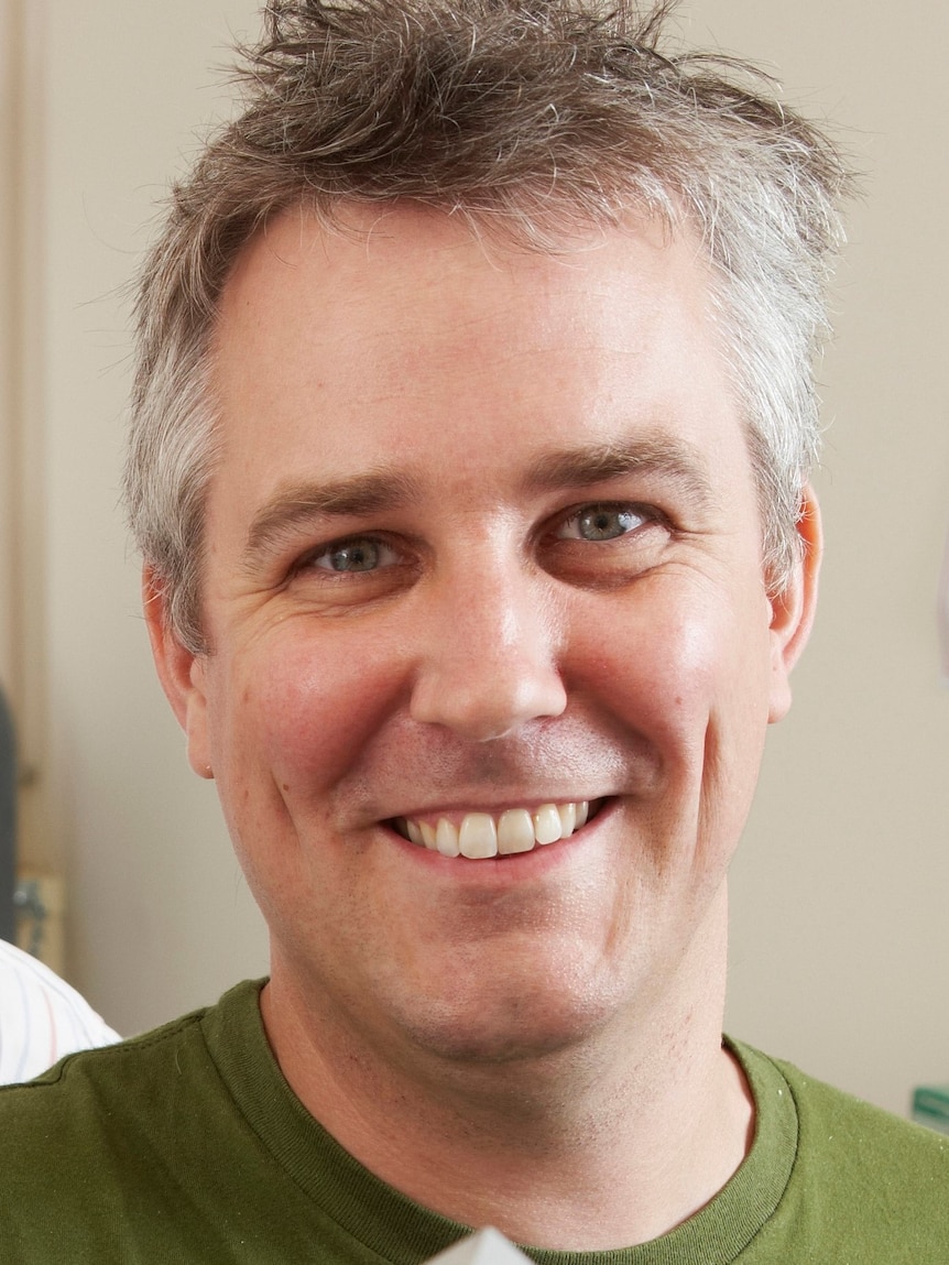 Head shot of a man smiling. 