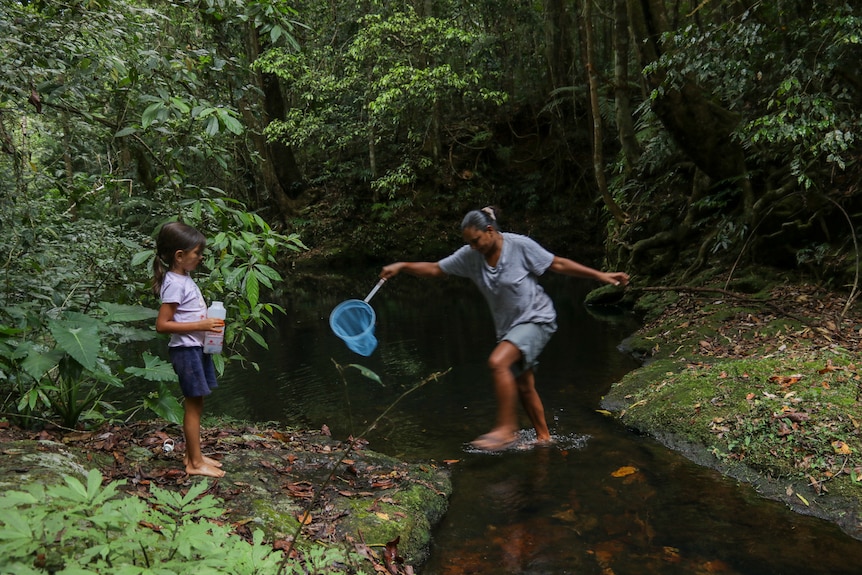 Georgina steps over a creek.