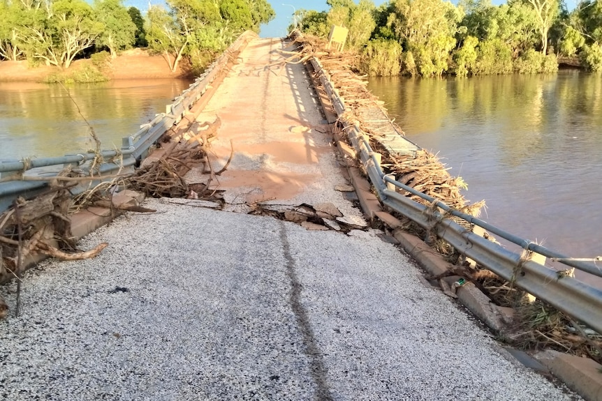 A bridge that has been warped and cracked by floodwaters.