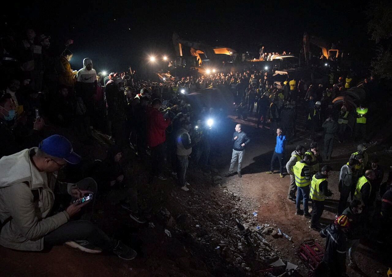 Dozens of people gather around the site as rescuers use machinery to dig to the trapped boy, February 4, 2022.