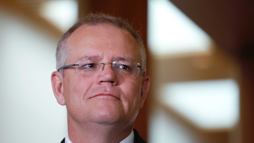 Scott Morrison looks to the side at parliament house