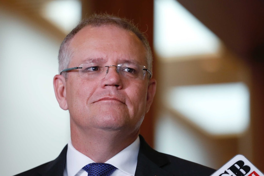 Mr Morrison is looking to the right of frame, and wearing a blue tie.