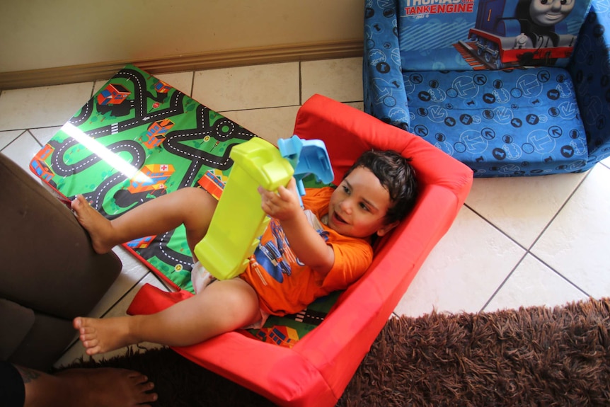 Two-year-old Nayte Slater smiles as he plays at the Gomeroi gaaynggal centre in Tamworth.