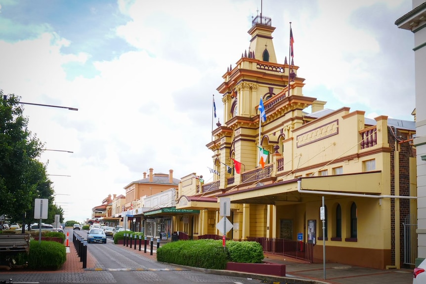 main street with old clock tower and car in street