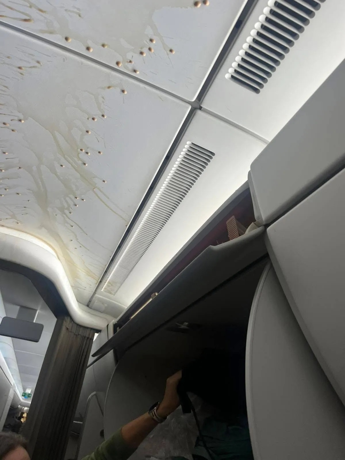 Droplets of coffee dripping down the sides of the plane ceiling.