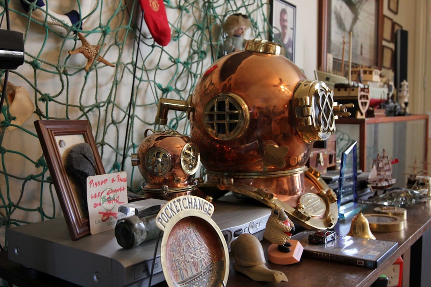 fishing net and bronze diving helmet in a room