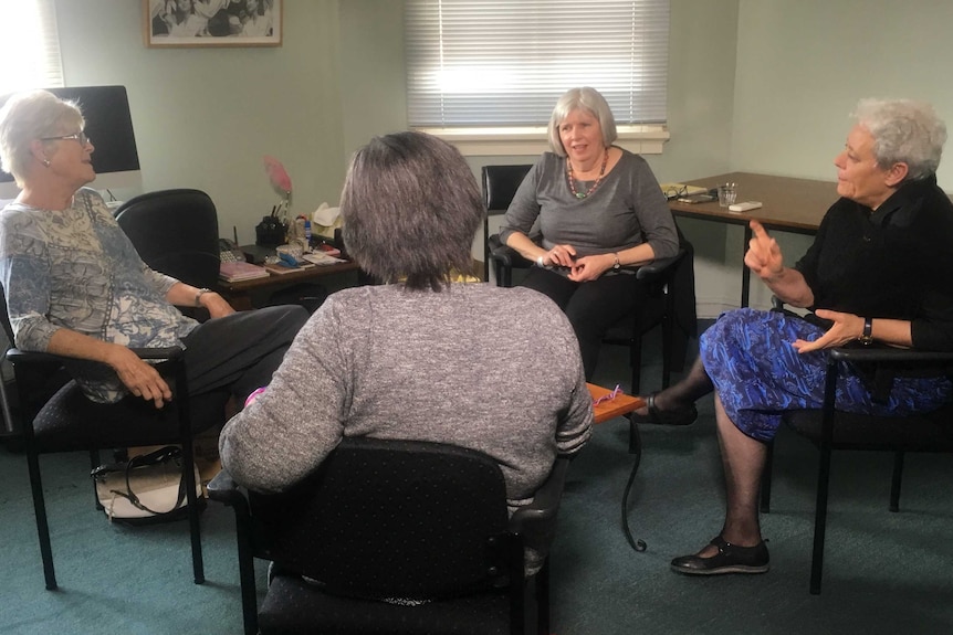 Four women in the Advanced Breast Cancer Group meet in an office