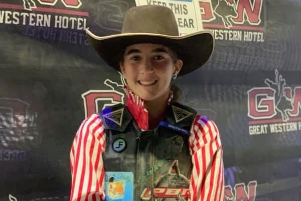Caydence Fouracre wearing her cowboy hat, chaps and protective vest at a PBR event.