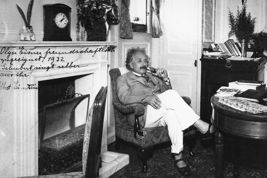 Portrait of physicist Albert Einstein sitting in an armchair and smoking a pipe, circa 1932.