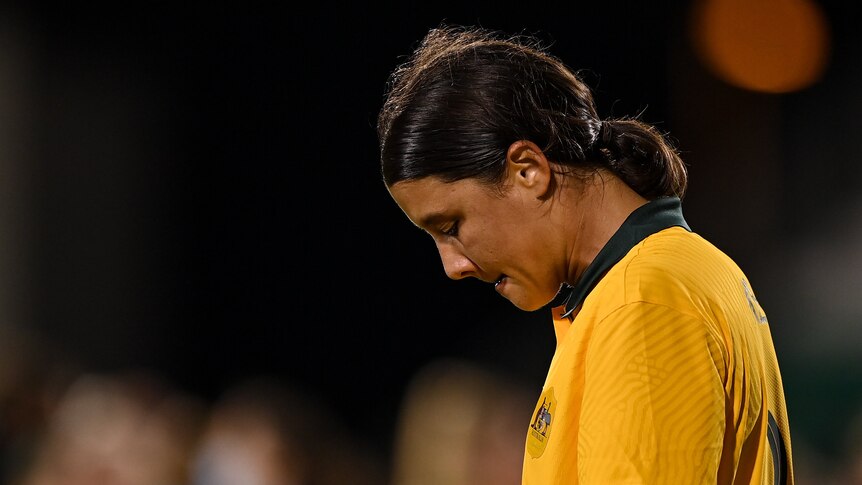 Sam Kerr has her head bowed and lips pursed