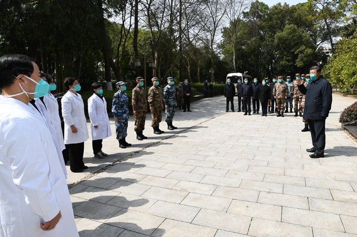 Chinese President Xi Jinping waves to medical staff and defence personnel