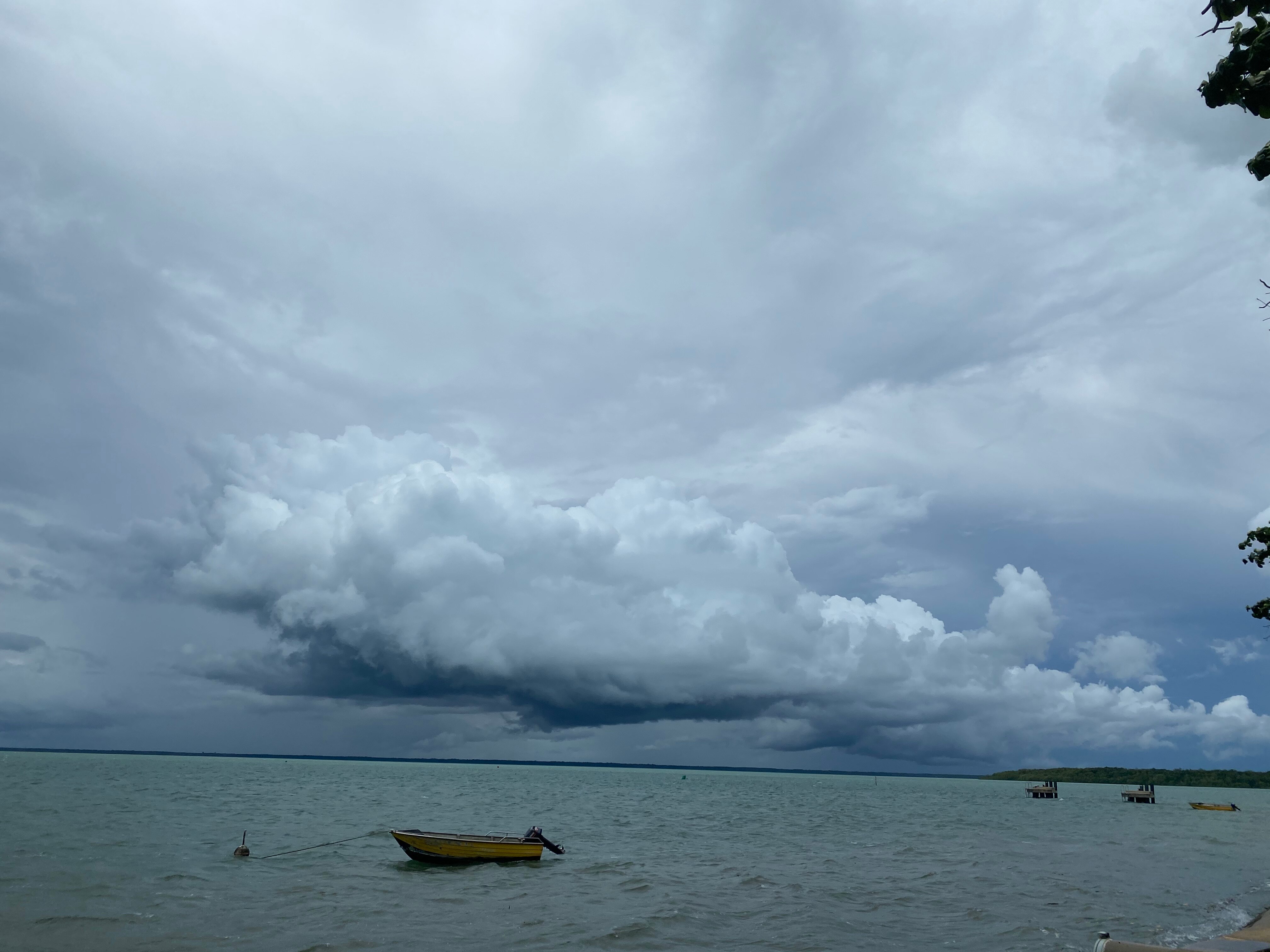 The ocean and storm clouds in the distance.
