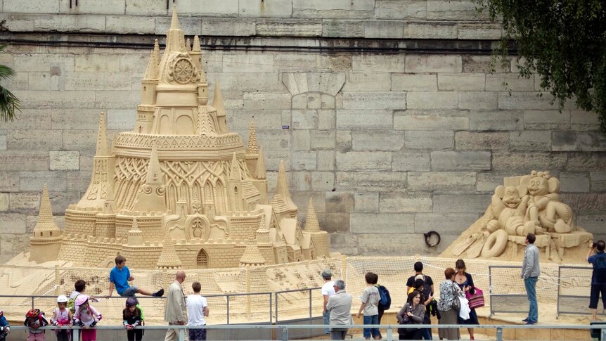 Sand castles line the River Seine during Paris Plage