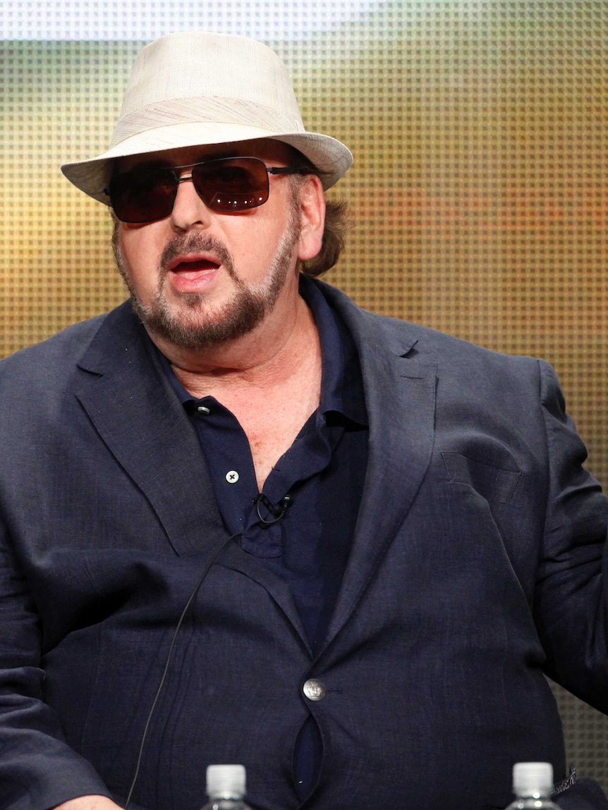 Film director James Toback wearing a white hat, sunglasses and a suit
