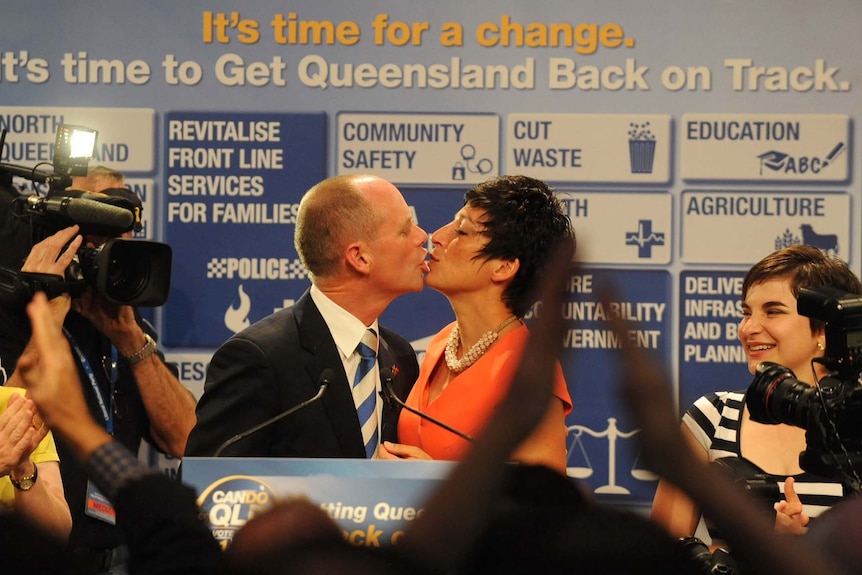 Liberal National Party (LNP) leader Campbell Newman celebrates with a kiss with wife Lisa