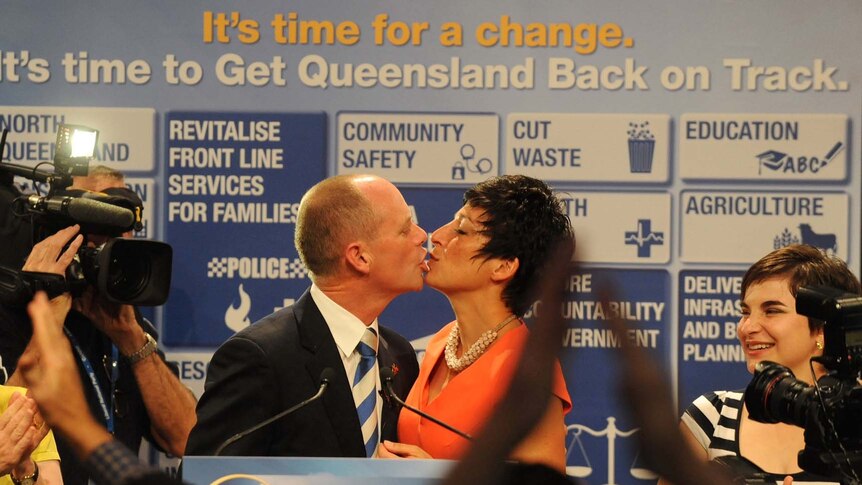 Liberal National Party (LNP) leader Campbell Newman celebrates with a kiss with wife Lisa