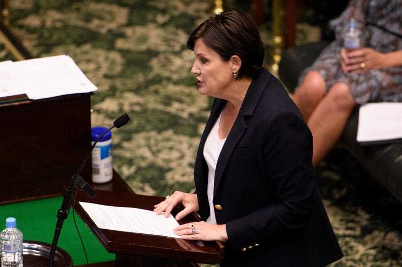 A woman at a lectern talking in parliament.