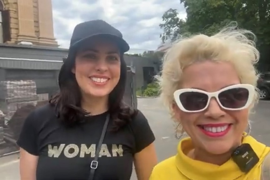 Moira Deeming and Kellie-Jay Keen-Minshull, both smiling broadly, as they stand near Victoria's parliament house.