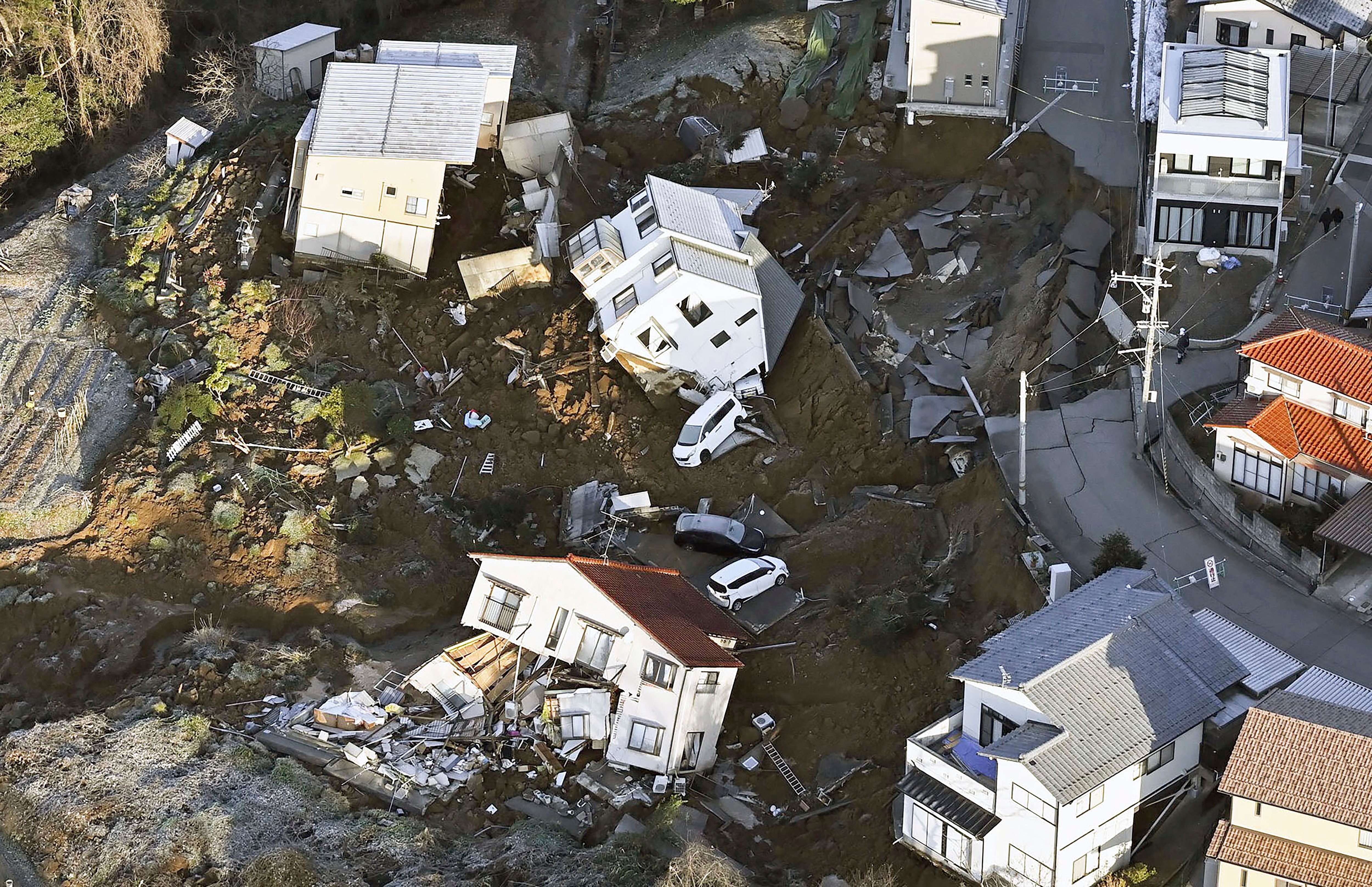 A view from above showing houses that have been damaged after an earthquake.