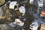 A view from above showing houses that have been damaged after an earthquake.