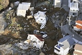 A view from above showing houses that have been damaged after an earthquake.