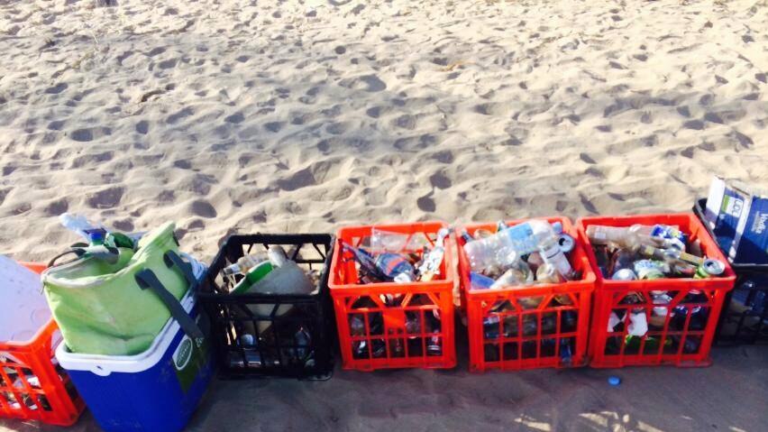 A bunch of rubbish on a sandy beach.