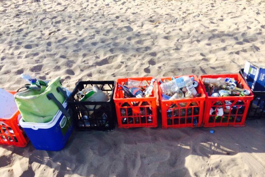 A bunch of rubbish on a sandy beach.