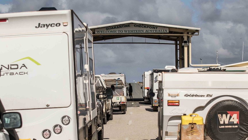 Cars lining up at a border check point.