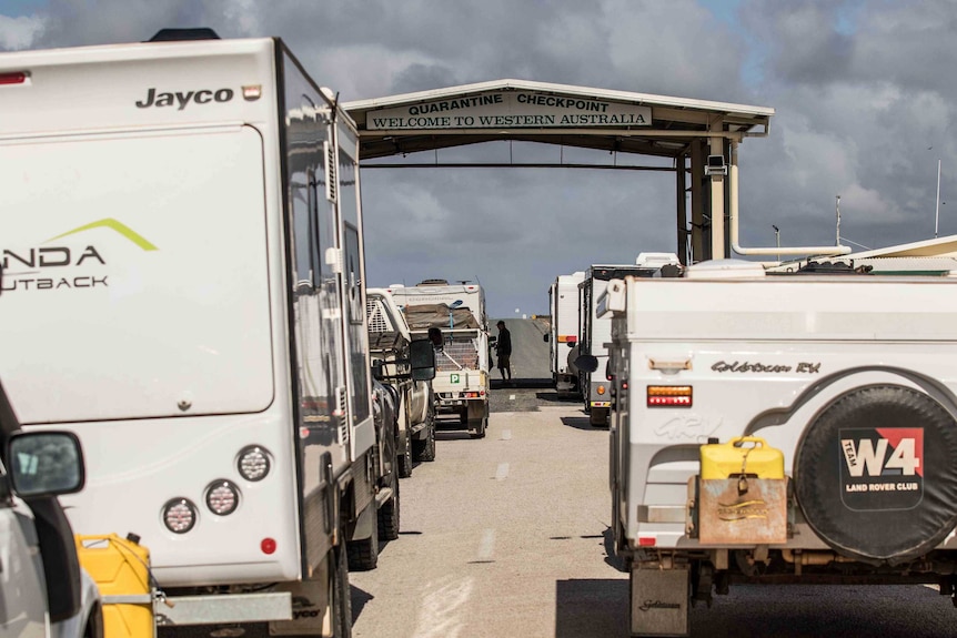 Cars lining up at a border check point.