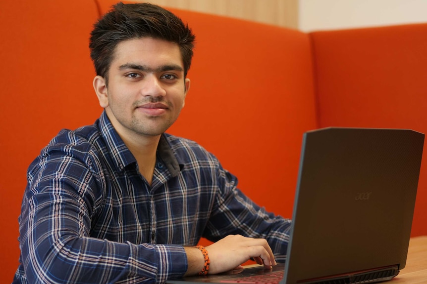 Research participant Vikrandh Kanumuru sits at his laptop.