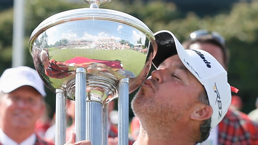 American Boo Weekley kisses the trophy after winning the US PGA Tour event in Fort Worth, Texas.