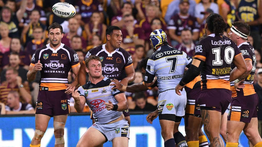 The Cowboys' Coen Hess (2L) reacts after his try against Brisbane at Lang Park.