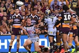 Coen Hess of the Cowboys (2L) reacts after scoring a try against the Cowboys at Lang Park.