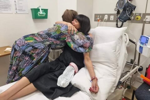 A woman getting IV fluids in hospital