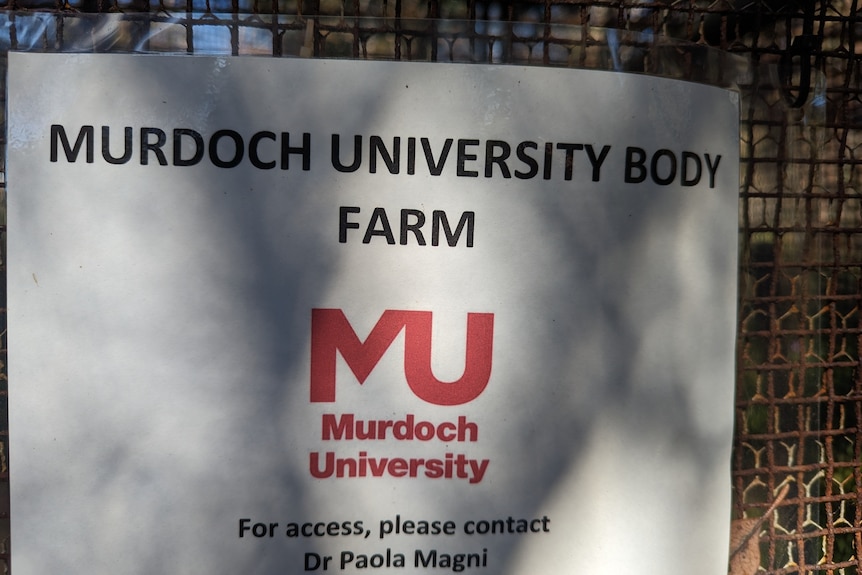 A photo of the Murdoch University Body Farm sign on the door of the wire mesh enclosure