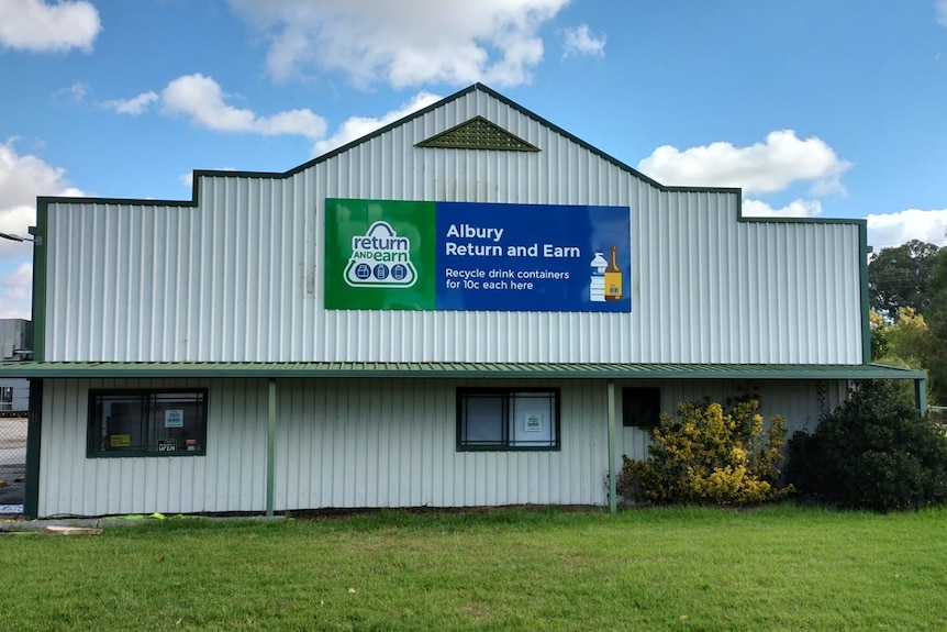 A tin building that says Albury Return and Earn on a sign