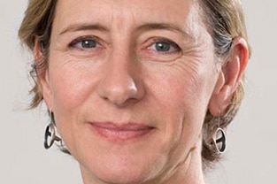 Head shot of Dr Gail Matthews wearing earrings and a black top.