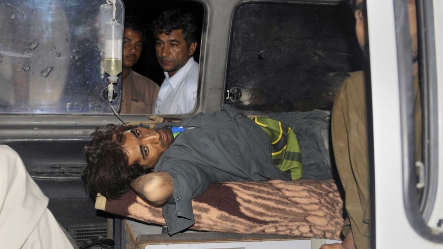 Pakistani Earthquake victim lies in an ambulance