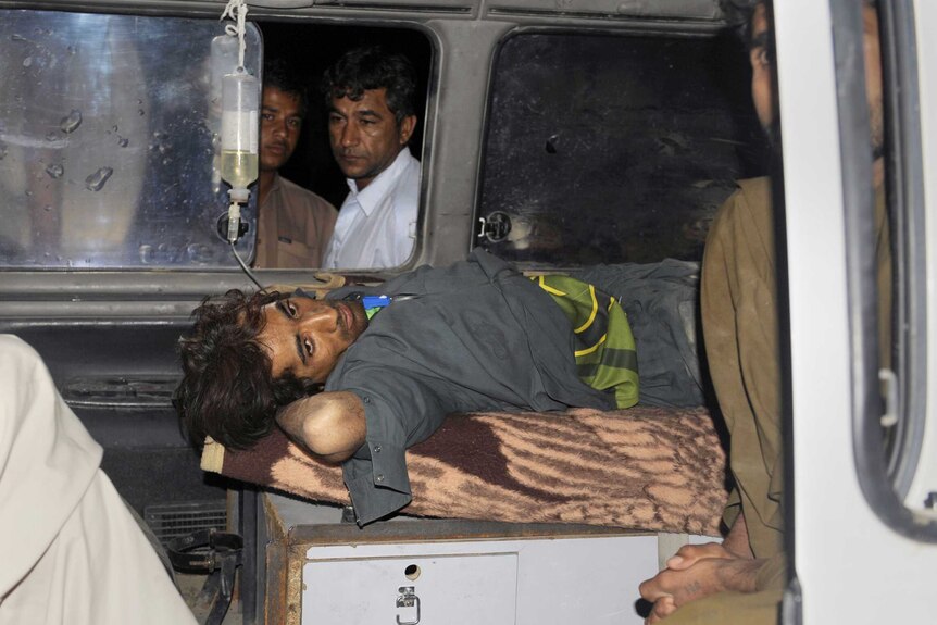 Pakistani Earthquake victim lies in an ambulance