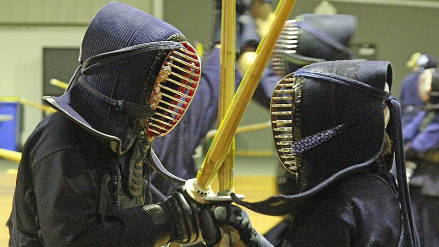 Two kendo practitioners face off