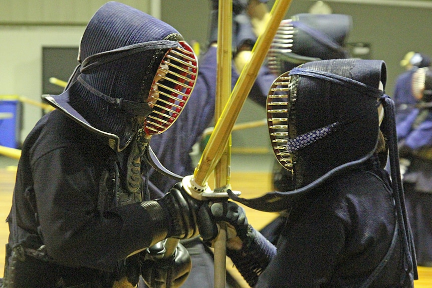 Two kendo practitioners face off