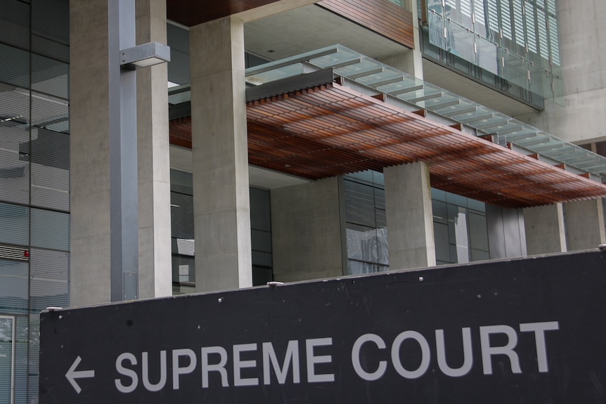 Sign for Brisbane Supreme Court and building in background.