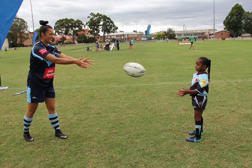 Female league players pass ball