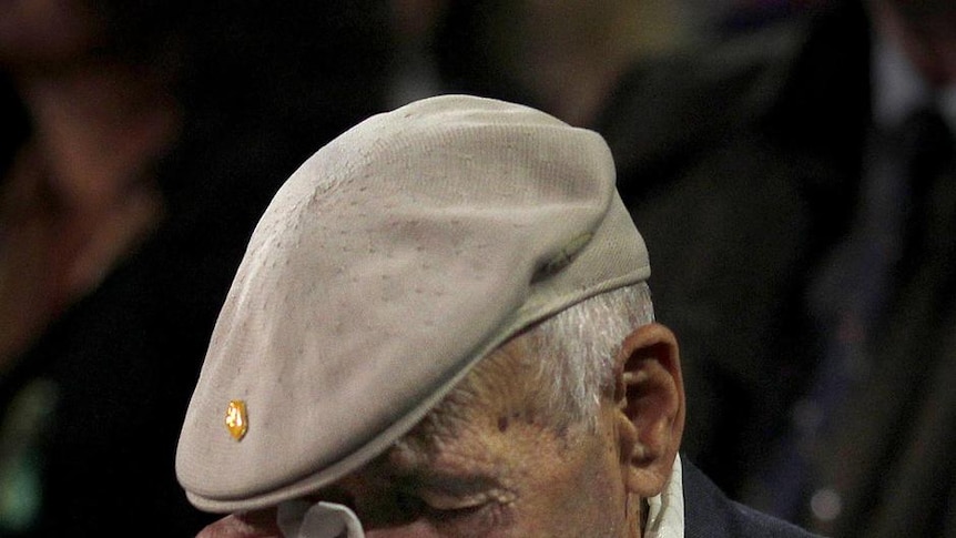 A former serviceman wipes away a tear during the dawn service at the Martin Place Cenotaph in Sydney.